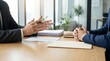 © Art Revolutionist - Human resources manager gesturing during interview with potential employee at workspace