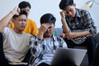 © Gatot - Group of Young Asian Men Looking Stressed and Frustrated While Working on Laptop