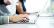 © peopleimages.com - Business people, typing and hands with laptop on desk, email marketing or creative assignment on web. Team, coworking and copywriting with tech for blog, online and post on social media in office