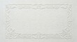 © IULIIA - White embossed paper frame with floral ornament for wedding invitation