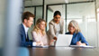 © REAL  - soft focus blurred photo of Professional business team collaborating in modern office, diverse colleagues discussing project on laptop, corporate group working together