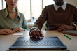 © TrueFrame Collective - Close up of young adult coworkers reviewing laptop together during office meeting, discussing digital workflow and teamwork. Suitable for business collaboration, training, or hiring content