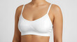 © Sakib - Woman wearing white bra and underwear, close-up of female torso