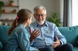 © miss irine - Happy grandfather talks with grandchild on sofa. Family connection across generations, smiling senior man shares stories. People connect at home using video calls for virtual family time.