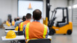© photo for everything - Industrial workers attend a safety training seminar with hard hats on desks, focused on a projection screen and a forklift in the background for practical learning