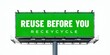 © antishock - Billboard displays message promoting reuse over recycling. Bright green text contrasts against dark background. Simple, direct communication.