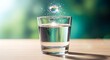 © sablengjago - A water-filled glass with a glowing orb, bokeh background and wooden surface