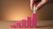 © sablengjago - Hand placing a person-shaped figure on top of a pink bar graph showing progression