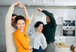 © JackF - Friends dancing. Cheerful young people dancing and drinking while enjoying home party on the room