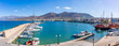 © robertharding - View of boats docking in Port of Hersonissos with mountains in the background in Crete, Greek Islands, Greece