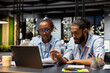 © DC Studio - Office manager and young woman doing internship reading inbox emails on laptop. Team leader doing trainee induction, analyzing data on notebook, interpreting statistical information