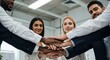 © manto - Diverse business team stacking hands.