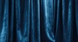 © fatma - Deep blue velvet fabric drapes with soft lighting creating a luxurious, theatrical ambiance