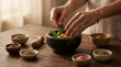 © Rohan Katwe - Hands preparing ayurvedic herbal blend in mortar with fresh leaves and spices on wooden table, showcasing natural healing, organic ingredients, traditional medicine and holistic wellness lifestyle