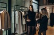 © Roman - Personal stylist helping young woman choosing fashion dress