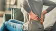 © sebra - Woman with back pain in home