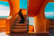 © VISTA by Westend61 - Teenager dancing energetically on stairs near terracotta walls and sea