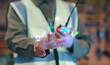 © HappyEva - Renewable energy transition and escaping the oil crisis concept featuring a worker pointing at a hologram that rejects fossil fuel barrels in favor of clean solar and wind electricity