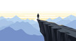 © Sabikur - A lone human silhouette stands on a wide, flat cliff edge looking towards a setting sun over layered blue mountains.