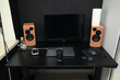 © Тарас Белецкий - Modern black desk setup with computer monitor, speakers, and coffee cup