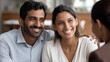 © Nataliya - Indian couple smiling while discussing retirement planning options with a faceless financial expert, multicultural financial planning, retirement investment, wealth consultation,