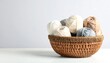 © brogan - Woven Basket with Yarn Balls on White.