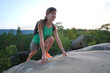 © bilanol - Sportive woman climbing alone on hillside rocky trail. Female hiker overcoming difficult cliff on wilderness path. Active lifestyle concept
