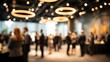 © rajmal - Blurred business networking event with people socializing under modern lighting in conference hall showcasing corporate gathering professional interaction communication atmosphere evening meetup