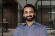 © insta_photos - Portrait of young happy indian business man executive looking at camera. Eastern male professional teacher, smiling ethnic bearded entrepreneur or manager posing in office, close up face headshot.