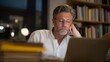 © forenna - Exhausted professional staring at complex retirement calculator results on laptop screen in cluttered home office surrounded by unopened financial planning books at midnight, ideal for retirement