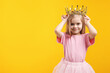 © New Africa - Beautiful little girl with crown dreaming about becoming queen on orange background, space for text