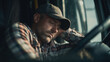 © Naufal - Tired male truck driver resting his head on hand inside cabin, showing fatigue and exhaustion during long haul work and demanding transport job.
