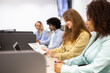 © ADDICTIVE STOCK - Coworking team collaborating at desk in modern office