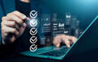 © wasan - Business professional checking digital checklist and data analytics dashboard on laptop screen, concept of project management, quality control, workflow automation, compliance audit, and AI technology