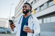 © Mimi - Male doctor talking on phone drinking coffee