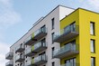 © Andrii Zastrozhnov - Contemporary apartment complex with yellow accent facade and repeating balconies featuring glass railings and geometric modern design