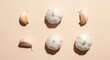 © sharp - Fresh Garlic Arrangement: A captivating top-down view of fresh garlic, artistically arranged on a light-toned backdrop, showcasing the natural beauty of the bulb and clove.