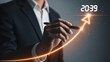 © Kunal - Businessman's hand draws a glowing orange upward trend line, symbolizing projected financial prosperity and strategic goal setting for 2039.