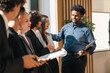 © chokniti - Business team meeting discussion collaboration presenting data analysis corporate teamwork diverse professionals planning strategy office communication partnership
