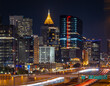 © Alexey Fedorenko - Atlanta Night Skyline with Light Trails on Highway and Illuminated Midtown Towers