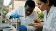 © anasa - A professional corporate cinematic close-up of a multi-ethnic scientific team huddled over a complex soil core sampler in a sterile AgriTech lab-corner