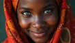 © Vadym - Close up of young african woman smiling warmly wearing traditional headscarf. Blue eyes sparkle with joy, warmth. Looks directly at camera with friendly gentle expression, radiating confidence, inner