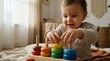 © Yuliia - Happy toddler boy playing with colorful wooden stacking rings toy in bright nursery room. Child development, early learning, educational toys concept.