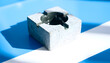 © Doni - Modern Square Concrete Ashtray with Dramatic Blue Lighting