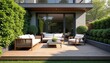 © Pete - Modern wooden deck with plush white outdoor sofa and chairs. Lush green garden surrounds comfortable patio furniture. This backyard offers relaxation and tranquil outdoor living.