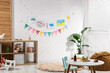 © New Africa - Stylish child's room with furniture, toys, beautiful drawings and bright flags. Interior design
