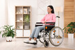 © New Africa - Woman in wheelchair at home. Space for text