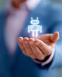 © Kingdola - Futuristic Hand and Robot: A person's hand tenderly cradles a glowing, luminous robot icon, creating an evocative image of human interaction with artificial intelligence.