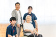 © buritora - Senior women and couples in wheelchairs, and male and female occupational therapists and physical therapists.