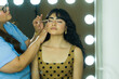 © AntonioDiaz - Latin model backstage, getting her makeup done by a professional, preparing for a photoshoot or event